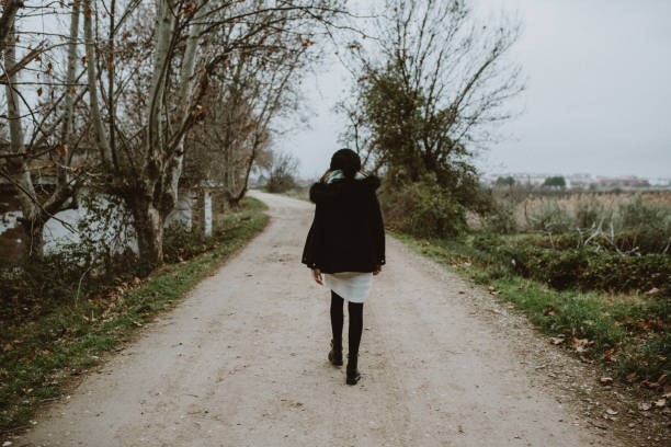 istock Young woman walking in a forest 1199257838