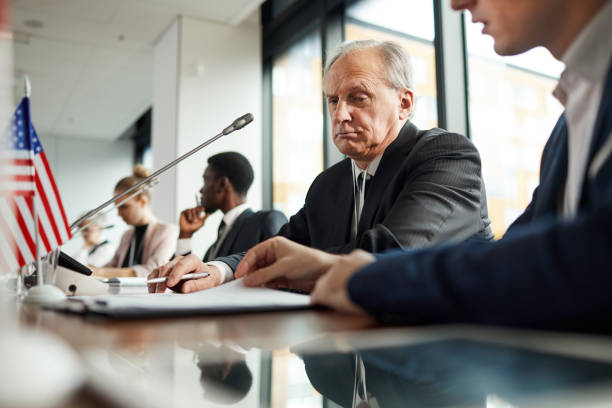 istock Senior businessman examining report 1199259120