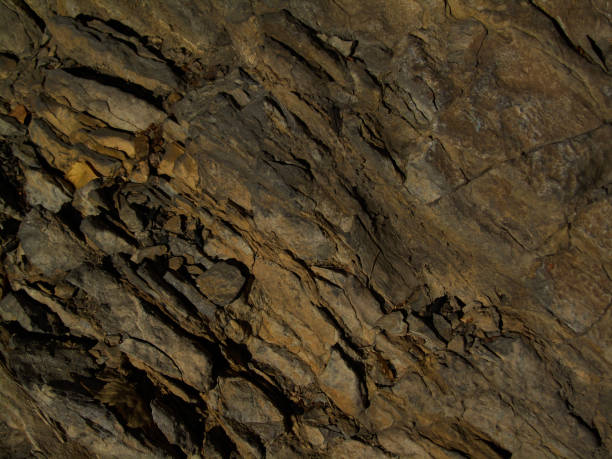 istock Dark brown stone background. Mountain texture. Close-up. Abstract grunge background. 1199260302