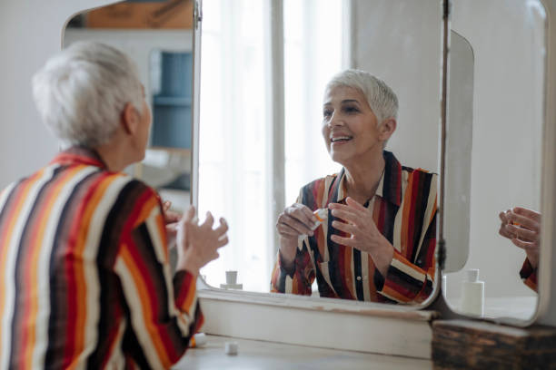 istock Pretty Senior Woman Using Cosmetics 1199260383