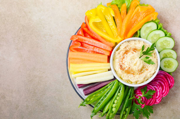 Hummus platter with assorted vegetable snacks. Healthy vegan and vegetarian food. Hummus platter with assorted vegetable snacks. Healthy vegan and vegetarian food. Top view, flat lay, copy space. dipping stock pictures, royalty-free photos & images