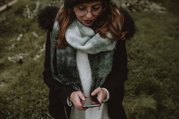 istock Young woman using a Smartphone in a forest 1199262114