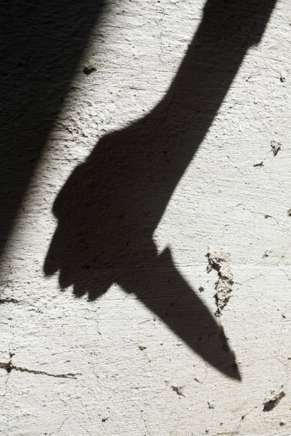 istock Shadow of the hand holding a knife 1199262144