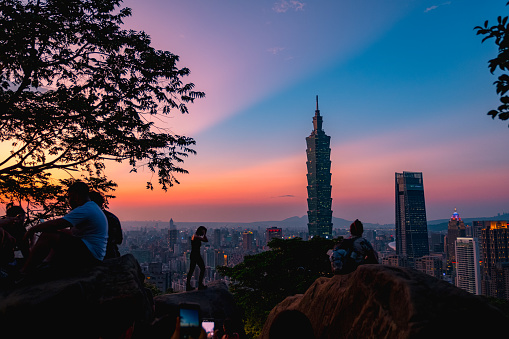Crowded people on the Elephant mountain viewpoint. The dusk scenery cityscape, Taipei 101 Observatory tower, and other buildings, Taiwan. 4th October 2019.