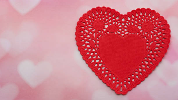 istock red valentines heart on a pink and white heart background with writing space 1199266182