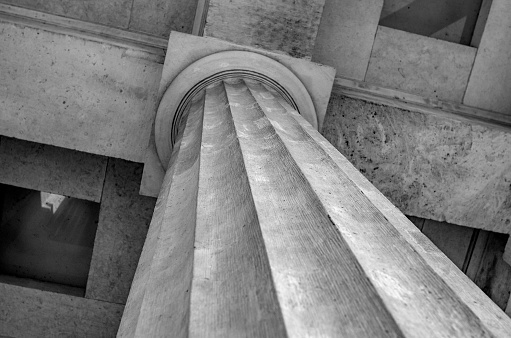 Antique stone column of a building close-up.