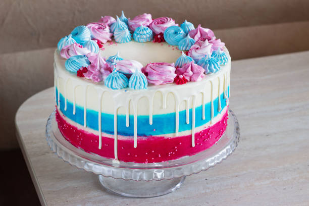 istock bright festive cake with multi-colored meringues on a table on a light background, holiday gender of the unborn child 1199269082