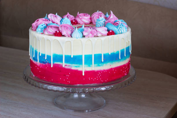 istock bright festive cake with multi-colored meringues on a table on a light background, holiday gender of the unborn child 1199269087
