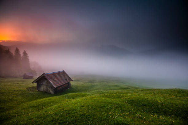 time lapse: mystical fog in the bavarian alps in germany - sunrise european alps mountain alpenglow imagens e fotografias de stock