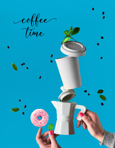 Trendy levitation. Flying line of coffee beans between ceramic coffee maker and espresso cup with saucer. Pink doughnuts with sugar sprinkles balance on finger. Blue mint background with palm leaves.