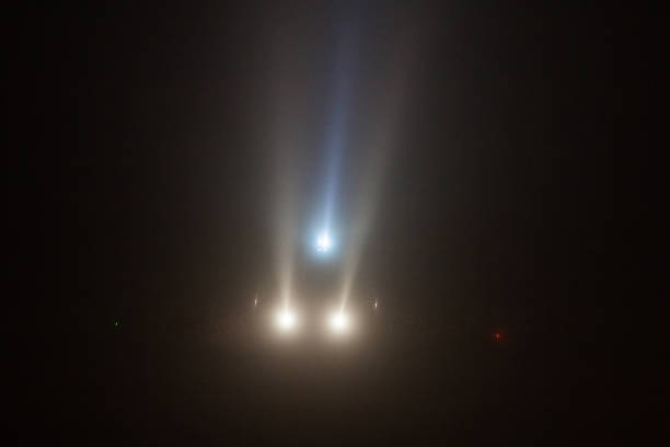 istock plane lands in the fog and headlights through 1199276053