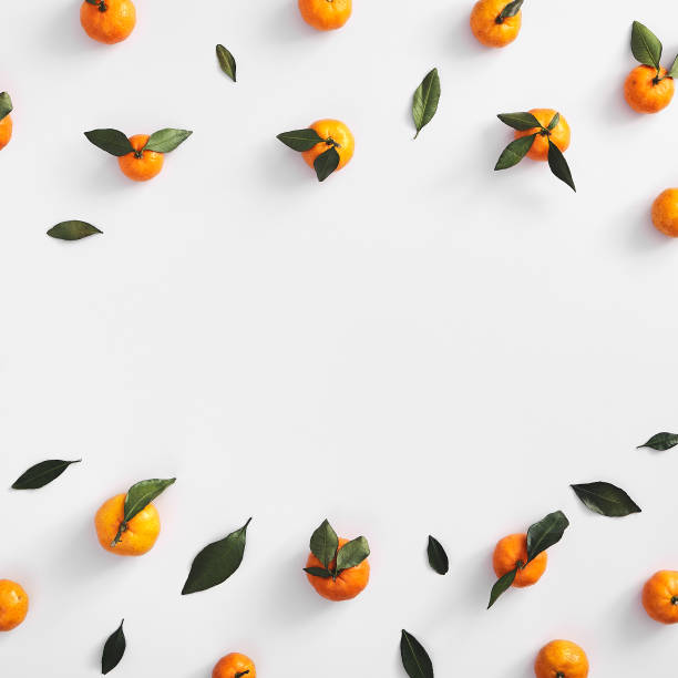 Ripe tangerines on white background top view