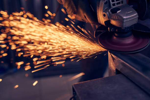 istock Worker cutting metal with grinder. Sparks while grinding iron 1199277434