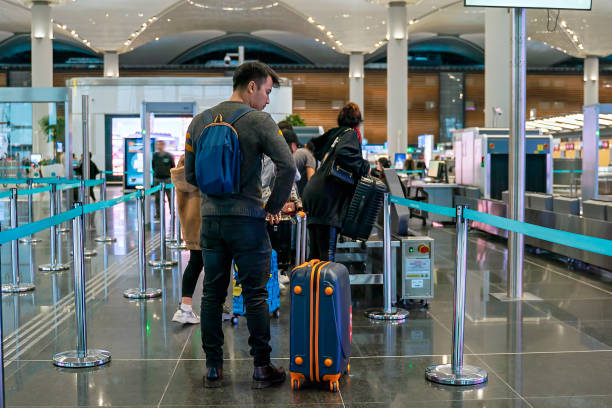 Passengers going trough security check at the airport stock photo