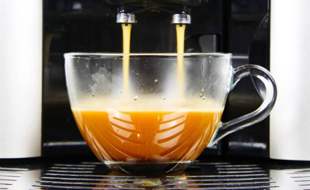 istock View on modern automatic coffee maker machine with isolated transparent glass cup filled with cafe crema 1199279902
