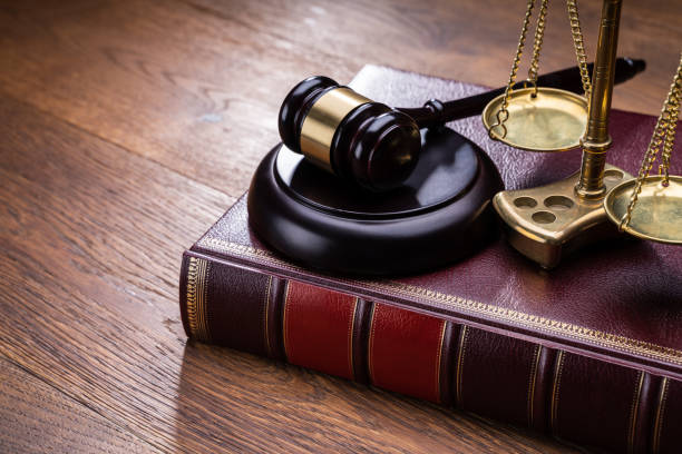 istock Gavel Near Book With Golden Scale 1199279916