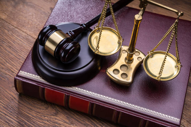 istock Gavel Near Book With Golden Scale 1199279923