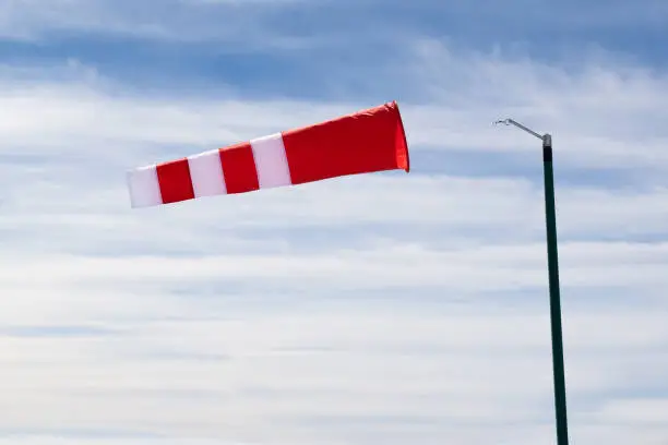 Striped Windsock In Mountains In High Wind