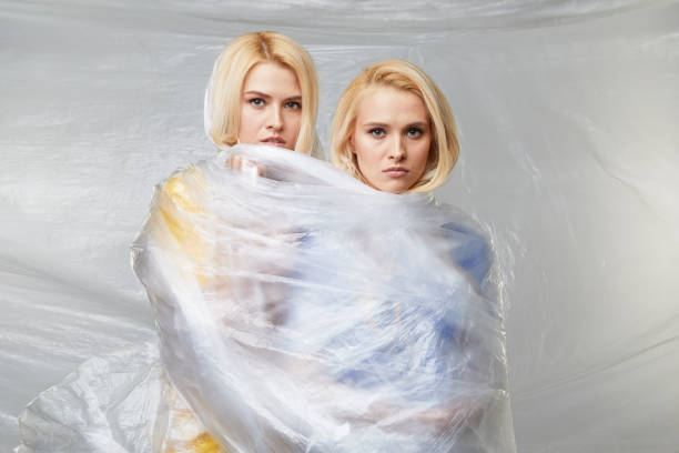 istock Two Young upset women wrapped in indestructible polyethylene. The problem of environmental pollution and poor ecology. Volunteers 1199281119