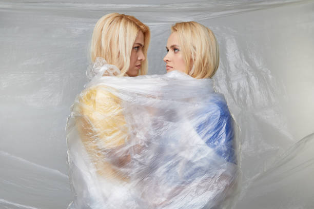 istock Two Young upset women wrapped in indestructible polyethylene. The problem of environmental pollution and poor ecology. Volunteers 1199281181