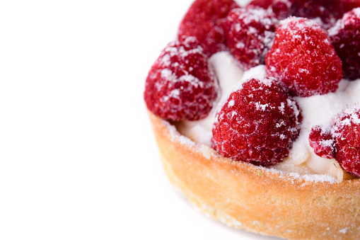 Fresh fruit raspberry tart on a white background. Homemade raspberry pie on a white isolated background, close-up