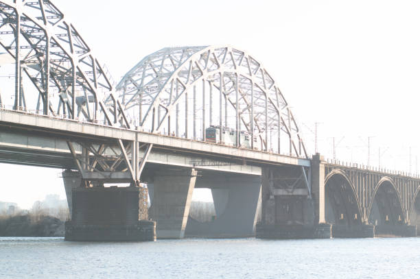 istock Big railway bridge. Train on the bridge. Railway bridge over the river. 1199283269
