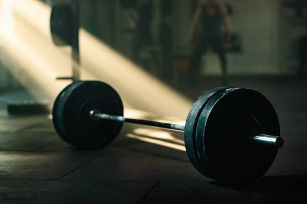 istock Barbell on the floor in a gym. 1199286507