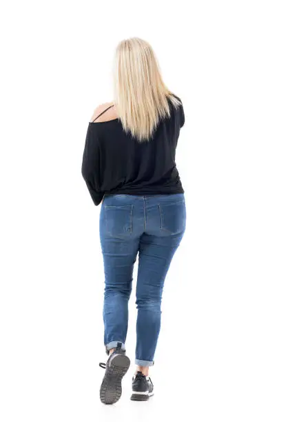 Back view of walking middle age casual woman with blonde hair talking on the cell phone. Full body length isolated on white background.