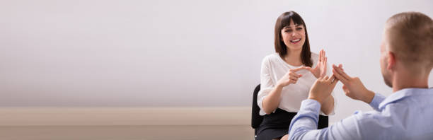 istock Young Woman And Man Talking With Sign Language 1199287187
