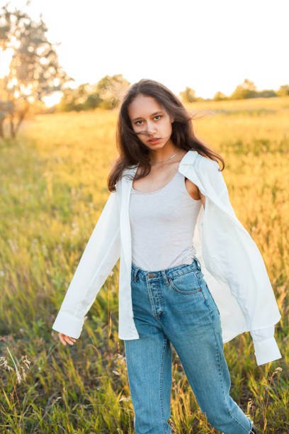 istock Young woman in posing outdoors at sunset 1199289382