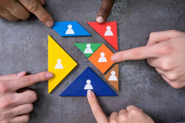 Photo of Person's Hands Completing Tangram Puzzle