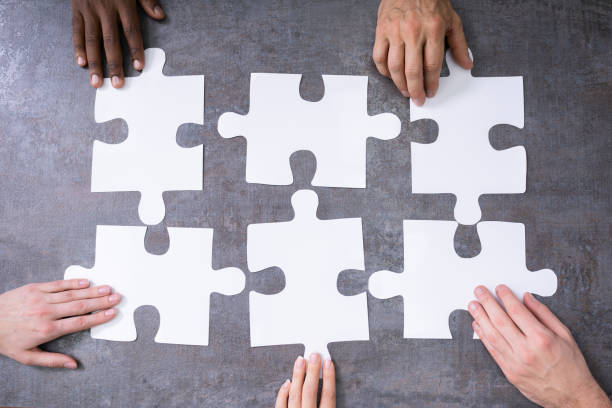 istock High Angle View Of Businesspeople Solving Jigsaw Puzzle 1199289495