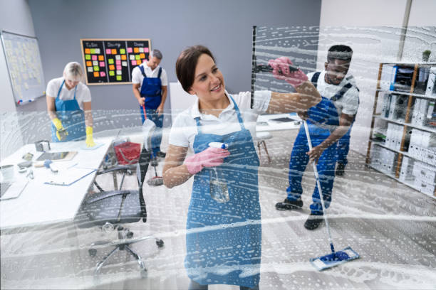 istock Happy Female Worker Cleaning Glass 1199289521