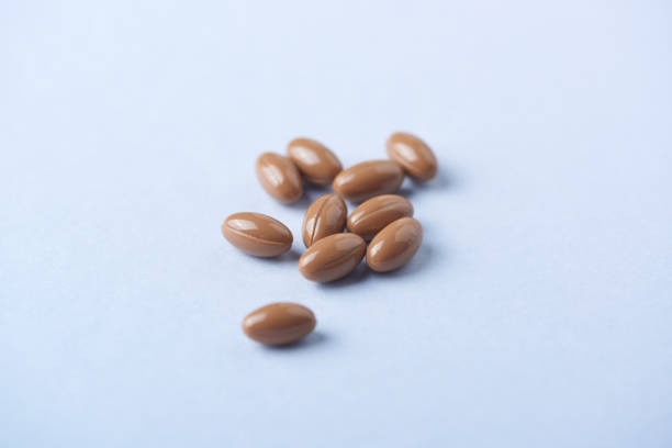 istock Vitamin K2 tablets on bright paper background. Close up. Copy space. 1199289776