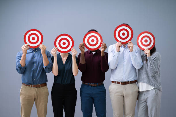 Businesspeople Holding Dartboard