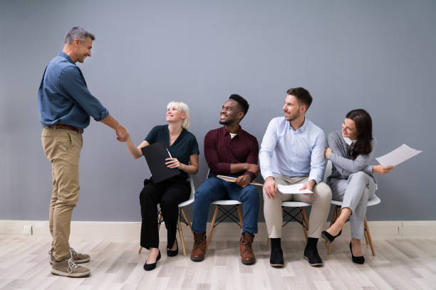 istock Businessman Shaking Hands With Female Candidate 1199289867