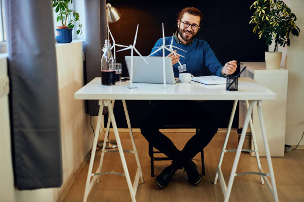 istock Young innovative caucasian bearded engineer sitting in his office and working on sustainable development. 1199289936