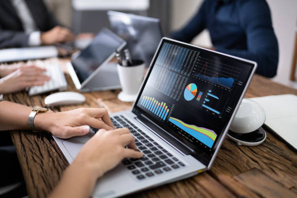 istock Businessperson Using Laptop With Graph On Screen 1199291036