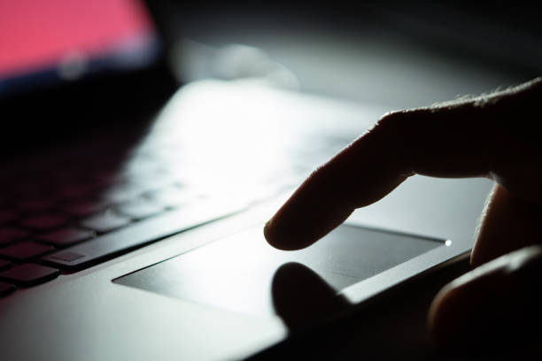 Close-up Of A Person's Hand Using Touchpad On Laptop