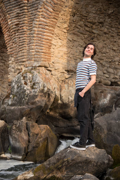 istock Young man posing in the field and with a bridge in the background 1199291424