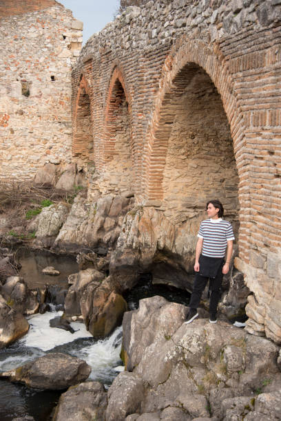 istock Young man posing in the field and with a bridge in the background 1199291472