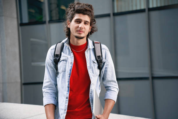 istock Freestyle. Student in jean jaket with backpack outdoors spending free time posing to camera joyful 1199291535