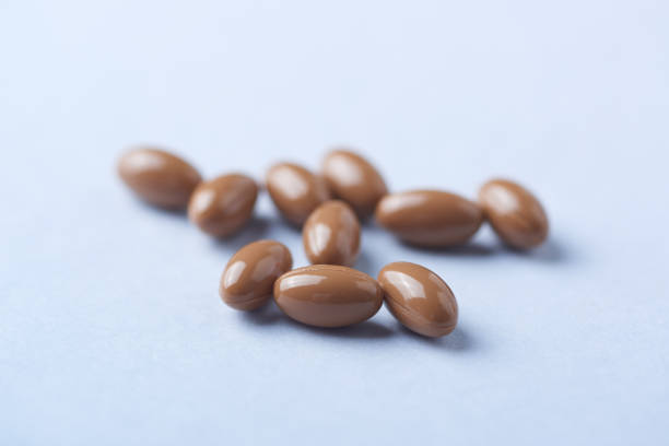 istock Vitamin K2 tablets on bright paper background. Close up. Copy space. 1199292676