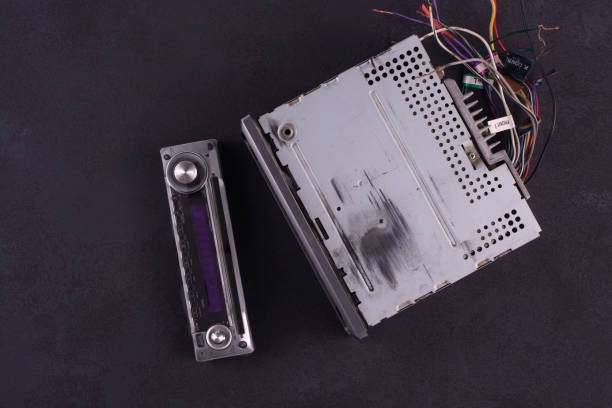 istock Old disk car radio with a removable panel on a black background. View from above. 1199293018
