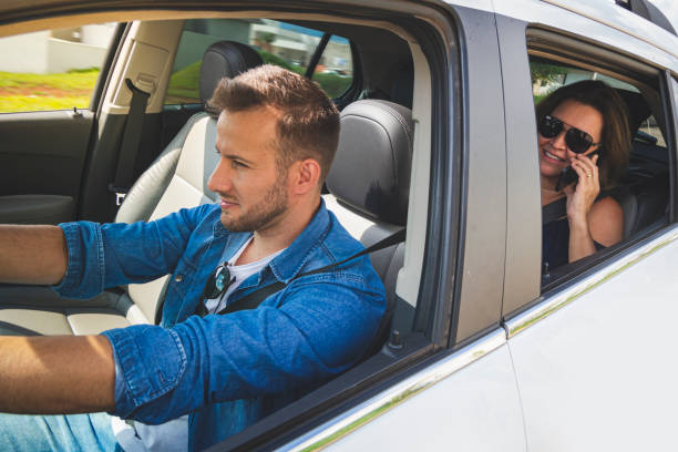 istock Driver inside a car with a woman as a passenger. 1199293058