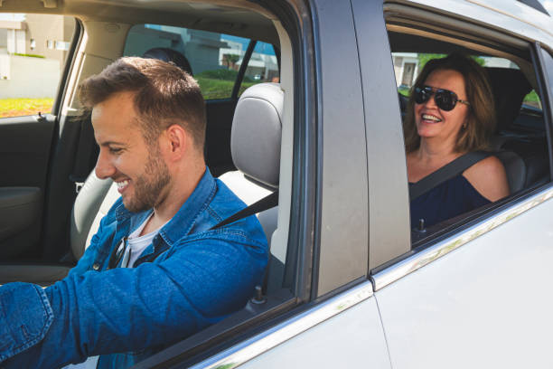 istock Driver inside a car with a woman as a passenger. 1199293073