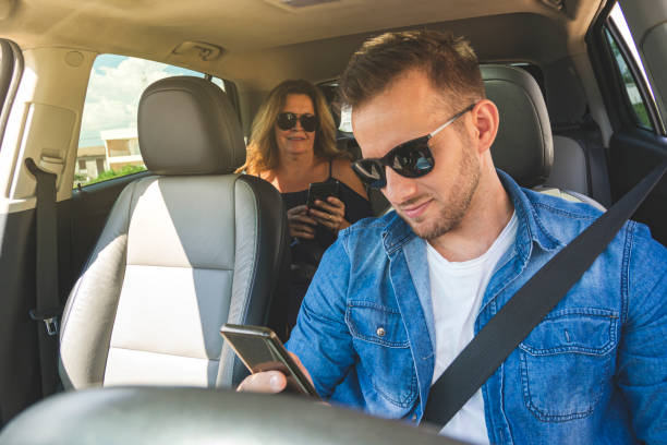 istock Driver inside a car with a woman as a passenger. 1199293091