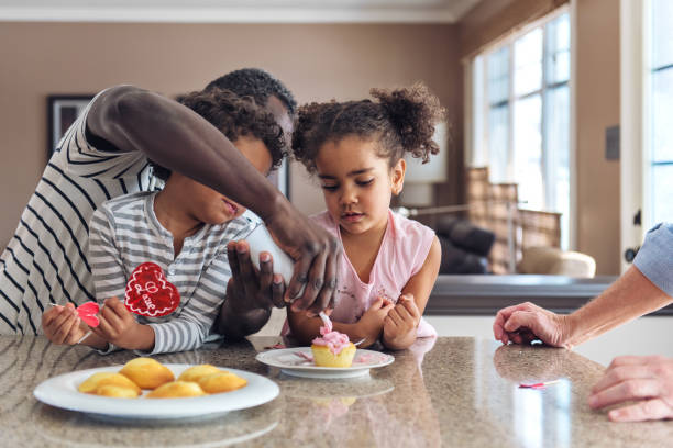 istock Multi-ethnic and multi-generation family preparing Valentine cupcakes 1199294024