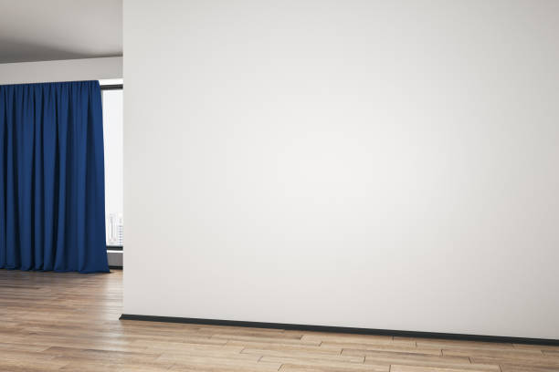 istock Empty modern spacious room with wooden floor, mock up blank wall and blue curtain. 1199294109