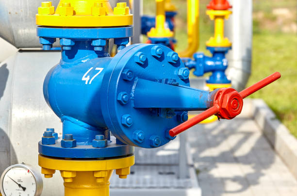 istock Blue valve on a yellow pipe at a gas processing plant 1199295245